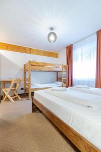 a bedroom with two beds and a bunk bed at Resort 7 Crai - Cabana Craiul Crailor in Zărneşti