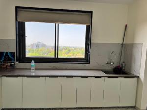 a kitchen with a window and a sink and a counter at Gangaur Residency in Jodhpur +55 photos