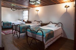 a bedroom with three beds in a room at Lal Hotel Bursa in Bursa