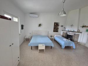 a bedroom with two beds and a fireplace at Villa leone 2 in Pisticci