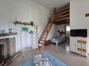 a living room with a fireplace and a tv at Villa leone 2 in Pisticci