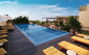 塞米亚克Kleo Seminyak, part of JdV by Hyatt的建筑物屋顶上的游泳池