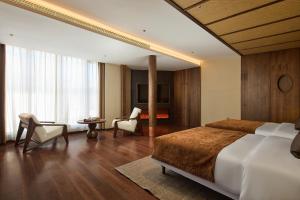 Postel nebo postele na pokoji v ubytování ARULA J Hotel