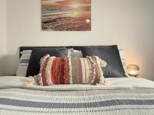 a bed with two pillows on top of it at 'The Elegant Comfort' - A Stunning Luxury 2-Bed Flat with Private Garden & Patio - Free Parking in Northampton
