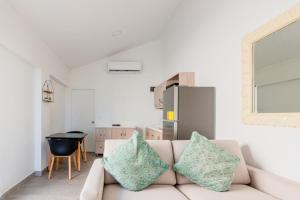 a living room with a couch and a kitchen at Arubas Life 408 in Noord