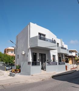 a white building on the side of a street at Nick and Helen in Rethymno Town