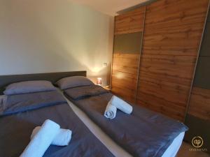 two beds in a bedroom with towels on them at Apartment Irene in Sečovlje