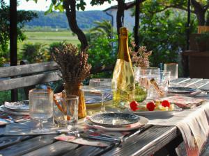 a table with a bottle of wine and plates of food at Apartment Irene in Sečovlje