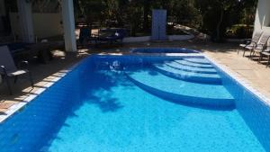 a swimming pool with blue water at Diani Serena House in Ukunda +2 photos