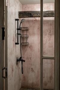 a room with a door with a sword on the wall at The Millers Room at Neromilos Watermill in Monastirákion +30 photos