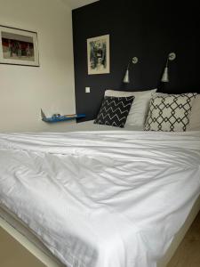 a large white bed in a bedroom with two lamps at Apartment Arte Vrbnik in Vrbnik +19 photos