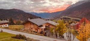 a house on the side of a road with mountains at Charmant appartement avec jardin et magnifique vue in Saint-Jean-de-Sixt +10 photos
