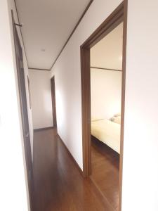 a bedroom with a mirror and a bed in it at Chiba Gateway House in Chiba