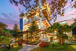 an exterior view of a house with a pool at ELC Boutique Hoi An Hotel in Hoi An