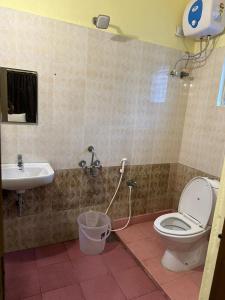 a bathroom with a toilet and a sink at Five stones By Earth Hotel Vadapalani in Chennai
