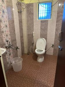 a bathroom with a toilet and a shower and a sink at Five stones By Earth Hotel Vadapalani in Chennai