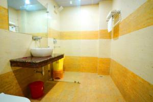a bathroom with a sink and a mirror at Hotel Amansara in Lucknow +31 photos