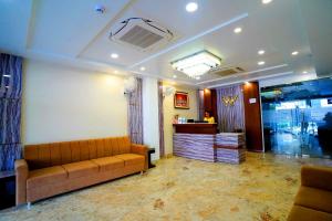 a living room with a couch and a counter at Hotel Amansara in Lucknow