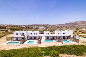 an aerial view of a white house with two swimming pools at Cato Agro 4, Seafront Villa with Private Pool in Karpathos
