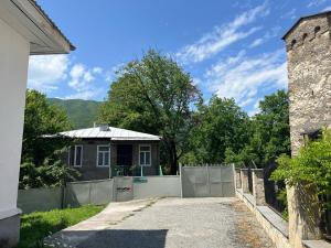 a house with a fence in front of a house at MACHABELl in Ambrolauri
