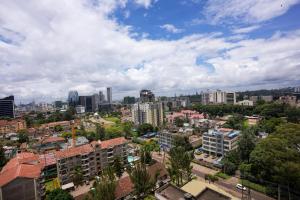 a view of a city with buildings and trees at Rooftop pool, gym and stunning city views in Nairobi