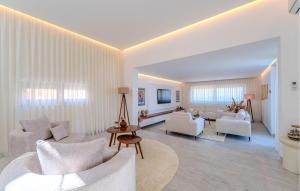 a living room with white furniture and white walls at Lovely Home In Preko With Sauna in Preko