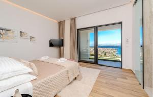 a bedroom with a bed and a large window at Lovely Home In Preko With Sauna in Preko