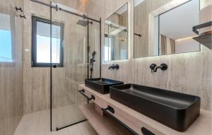 a bathroom with a black sink and a mirror at Lovely Home In Preko With Sauna in Preko +43 photos
