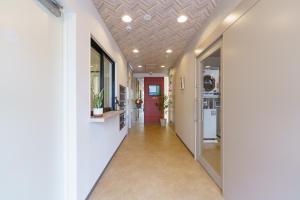 a hallway of an office building with a red door at USP HOTEL Kitahorie in Osaka