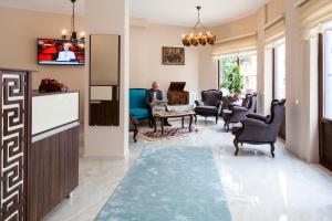 a man sitting in a living room with a tv at Lal Hotel Bursa in Bursa