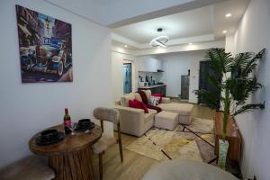 a living room with a couch and a table at Rooftop pool, gym and stunning city views in Nairobi