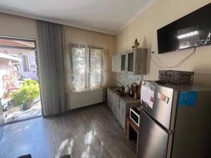 a kitchen with a stainless steel refrigerator and a window at Gsth Mila in Tbilisi City