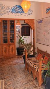 a living room with a couch in a room at Surf hostel Morocco in Tamraght Ouzdar