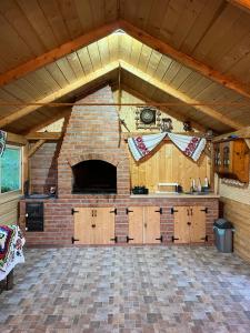a large room with a kitchen and a brick oven at Wild Glamping Cornereva in Cornereva