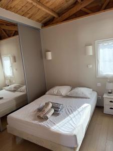 a bedroom with two beds and a wooden ceiling at CHALET GRUISSAN 10 Places 4 Chambres CONFORT & VUE sur MER in Gruissan