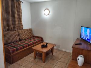 a living room with a couch and a table at Les Estives de Cauterêts in Cauterets