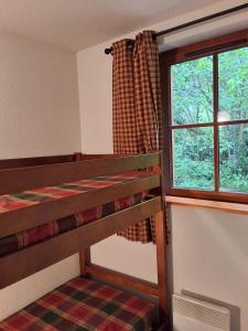 a room with a bunk bed and a window at Les Estives de Cauterêts in Cauterets +32 photos