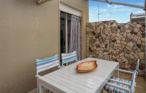 a hat sitting on a table on a balcony at Cozy Apartment In Santa Croce Camerina in Santa Croce Camerina +9 photos