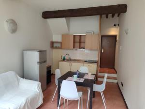 a small kitchen with a table and chairs in a room at A casa di Raffaella in Parma