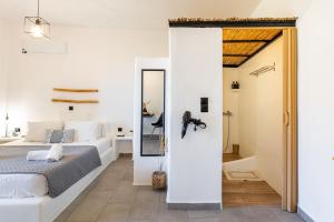 a bedroom with a bed and a mirror at THIRAMNA Apts KYTHNOS in Mérikhas