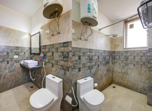 a bathroom with a toilet and a sink at Hotel Wedlock - Golf Course Extension Road in Gurgaon +13 photos