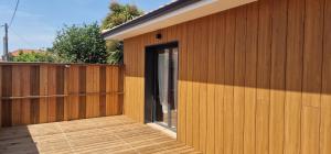 a wooden building with a window on the side of it at Chalet in Le Teich