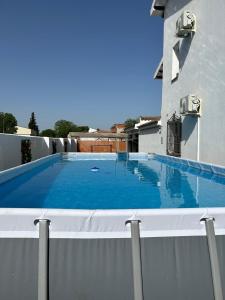 a swimming pool on the roof of a house at Casa Rural La Gospa in Urda