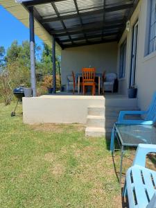 a patio with a table and chairs on a house at Lake View Cottage Unit 7 in Rosetta