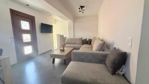 a living room with a couch and a table at Harmony Home in Kouspádes