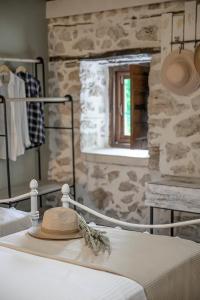 a hat sitting on top of a bed in a room at Fairy Cave studio in Monastirákion