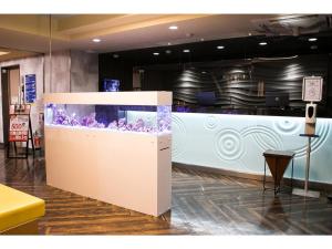a large aquarium in the middle of a room at Smile Hotel Kumamoto Suizenji - Vacation STAY 73061v in Kumamoto