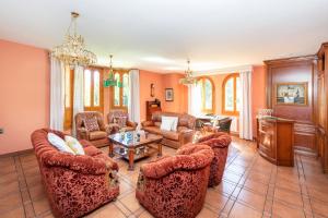 a living room filled with furniture and a chandelier at Maravilloso chalet con piscina en Baza in Baza