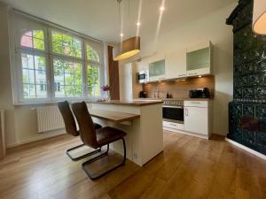 a kitchen with a counter and a table with chairs at Brot & Auszeit in Falkensee