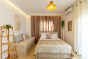 a bedroom with a bed and a ladder and a window at Villa Shafeti in Ksamil